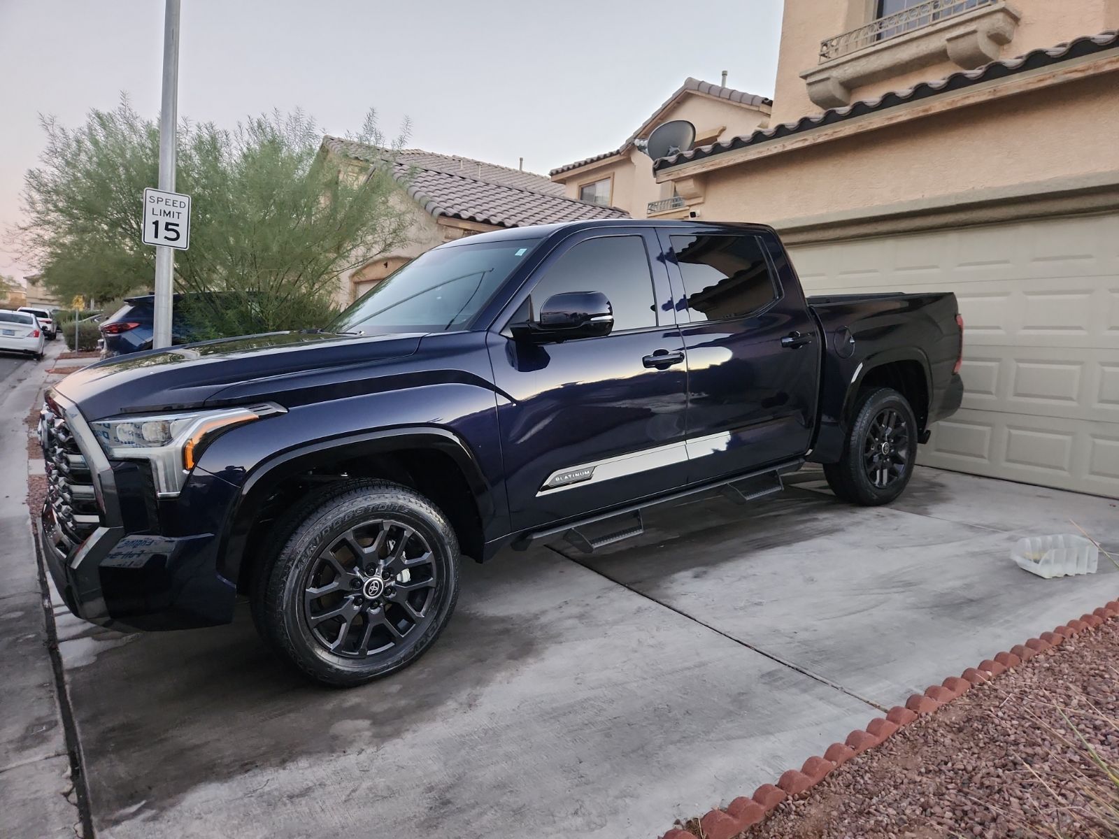 Detailed dark blue Toyota Tundra Platinum with a deep glossy finish parked in a driveway